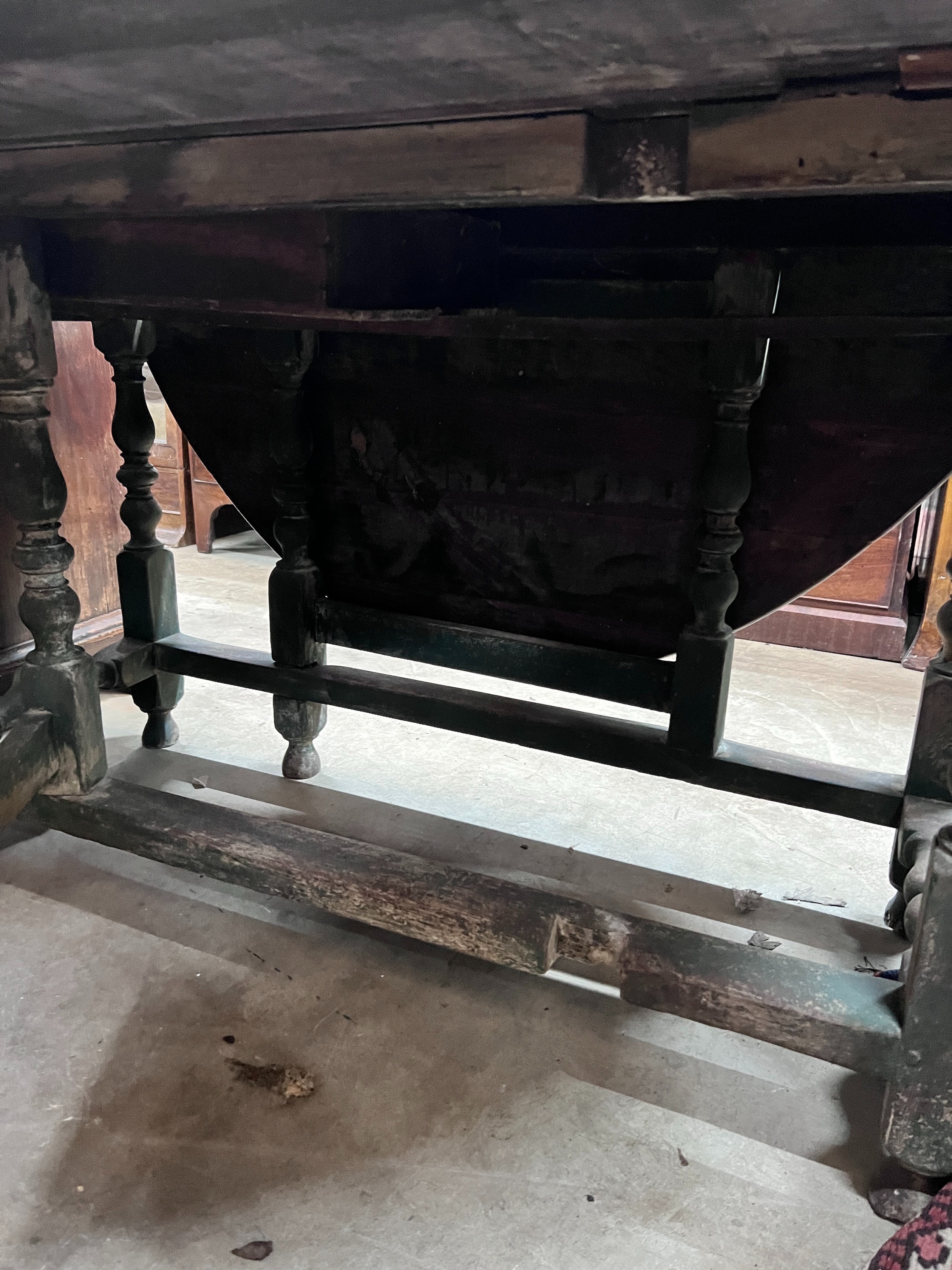 An 18th century oak gateleg dining table, the turned underframe with traces of old paint, length 123cm, depth extended 134cm, height 72cm *Please note the sale commences at 9am.